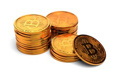 Three small stacks of Bitcoins with one coin leaning against a small stack