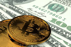 Two Bitcoins laying on U.S. currency