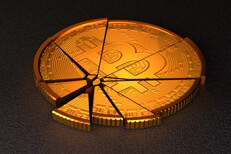 Broken Bitcoin with spot lighting representing cryptocurrency market crash or steep price decline