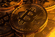 Photo showing random pile of Bitcoins with camera focused on center coin