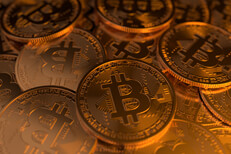Random pile of Bitcoins Pile of Bitcoins scattered randomly with soft golden lighting to right