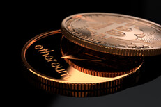 Bitcoin and Ethereum coins on glossy reflective black surface