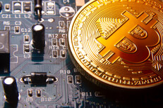 Bitcoin at angle on a graphics card showing circuits and capacitors