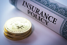 Insurance policy next to stack of Bitcoins concept for Bitcoin insurance
