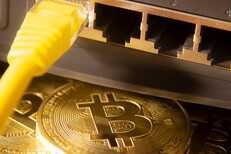 Bitcoins with yellow LAN Cat-5 cable and router ports