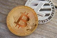 Bitcoin and Litecoin Bitcoin with Litecoin on wood background