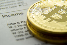 Bitcoins stacked on income tax form Bitcoins stacked on an IRS 1040 tax form showing the Income information section
