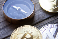 Crypto coins with compass Cryptocurrency coins next to navigation compass