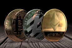 Ethereum, Litecoin, and Bitcoin standing on edge on wood surface