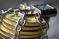 Secure Bitcoins Stack of Bitcoins wrapped with chains and locked with a padlock