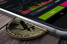 iPhone with Bitcoin in slot iPhone with Bitcoin inserted into slot concept for mobile Bitcoin apps, profits, or trades