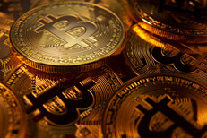 Random bitcoins dim lit Pile of random Bitcoins in low light with soft spotlight on one coin