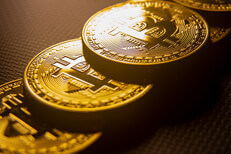 Bitcoins stacked Bitcoins stacked in order with window light in background