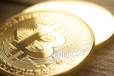 Two bitcoins on wood Two bitcoins laid on wood background with shallow depth of field and highlight