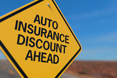 Auto insurance discount road sign Yellow road sign reading Auto Insurance Discount Ahead