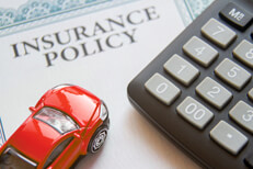 Auto insurance policy with calculator Auto insurance policy with calculator and small red toy car