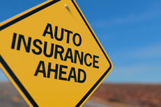 Auto insurance ahead road sign Yellow road sign stating Auto Insurance Ahead