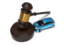 Blue car crashed into gavel Blue car crashed into base of gavel isolated on white liability insurance concept image