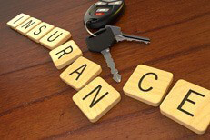 Car keys on desk insurance concept Car keys and key fob displacing letters in word insurance on desk