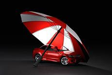 Car insurance protection Insurance protection concept of red car under red and white umbrella with dark background