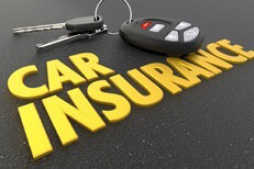 Car keys car insurance concept Auto insurance concept image showing car keys and key fob resting on shiny car insurance text