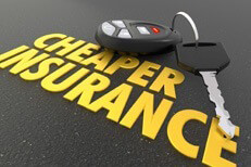 Cheaper car insurance concept Shiny gold Cheaper Insurance words on asphalt with car key and key fob