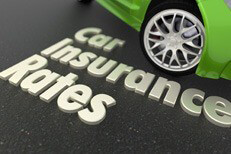Car insurance rates text next to green sports car on asphalt road