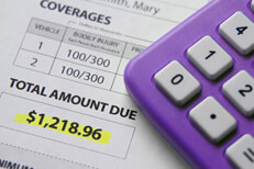 Calculator with car insurance bill Car insurance bill showing amount due with purple calculator