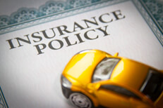 Car insurance policy short focus Toy car on top of insurance policy certificate with short depth of field