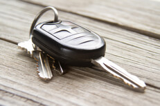 Car keys on weathered wood background Car keys placed on weathered wood planks with soft shadows