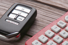 Vehicle remote entry with calculator Car insurance cost concept photo of remote entry and calculator