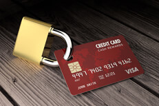 Credit lock red card Red credit card padlocked on old wood surface