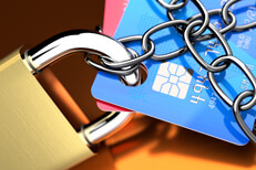 Close up photo of credit cards with padlock and chains