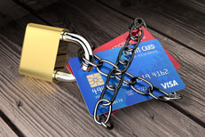 Credit lock concept of two credit cards wrapped in chain links locked to padlock