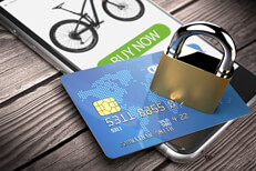 Mobile credit card with padlock iPhone showing buy now screen with credit card and padlock on weathered wood planks