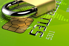 Padlock on green credit card Angled view of padlock lying on green credit card with EMV chip