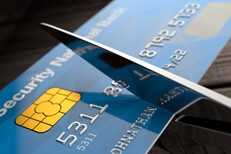 Shiny chrome scissors cutting credit card