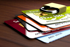 Stack of credit cards with padlock Stack of shiny credit cards with small padlock on top