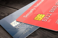 Visa and Mastercard on wood Angled view of Mastercard and Visa credit cards on wood surface