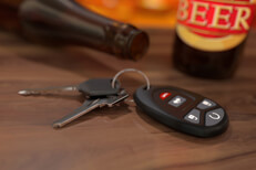 Beer bottles with car keys on bar Car keys on wood bar with beer bottles in background