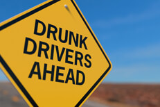 Yellow road sign reading Drunk Drivers Ahead DUI concept image
