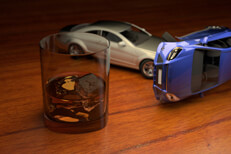 Two car rollover accident caused by a drunk driver next to glass of bourbon