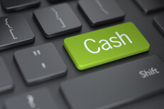 Dark keyboard with large green Cash button concept for putting investments into cash