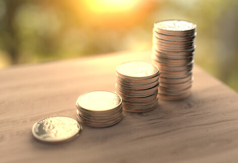 Stack of quarters on table with early morning light