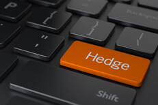 Hedge keyboard key Dark computer keyboard with large orange Hedge key representing hedging investments online