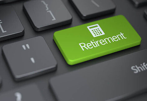 Retirement calculator Dark laptop keyboard with large green Retirement key with calculator icon