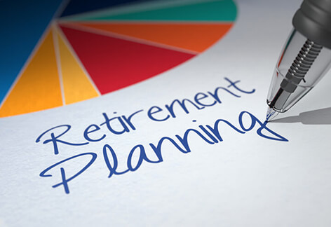 Retirement Planning script Paper with colorful pie chart and Retirement Planning written by ballpoint pen