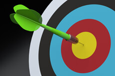 Green dart in center of colorful target on dark background