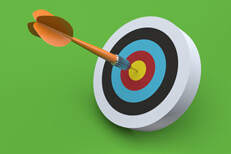 Dart hits target Orange dart hits colorful target with green background
