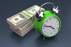 Alarm clock and stacks of money concept for time is money or time value of money